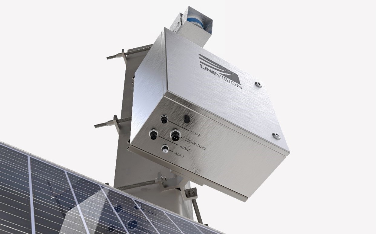 Close-up of a metallic device labeled 'LineVision' mounted on a structure with visible screws and connectors labeled 'LiDAR,' 'Solar Panel,' 'AUX-2,' and 'AUX-1.' A solar panel is partially visible in the foreground.
