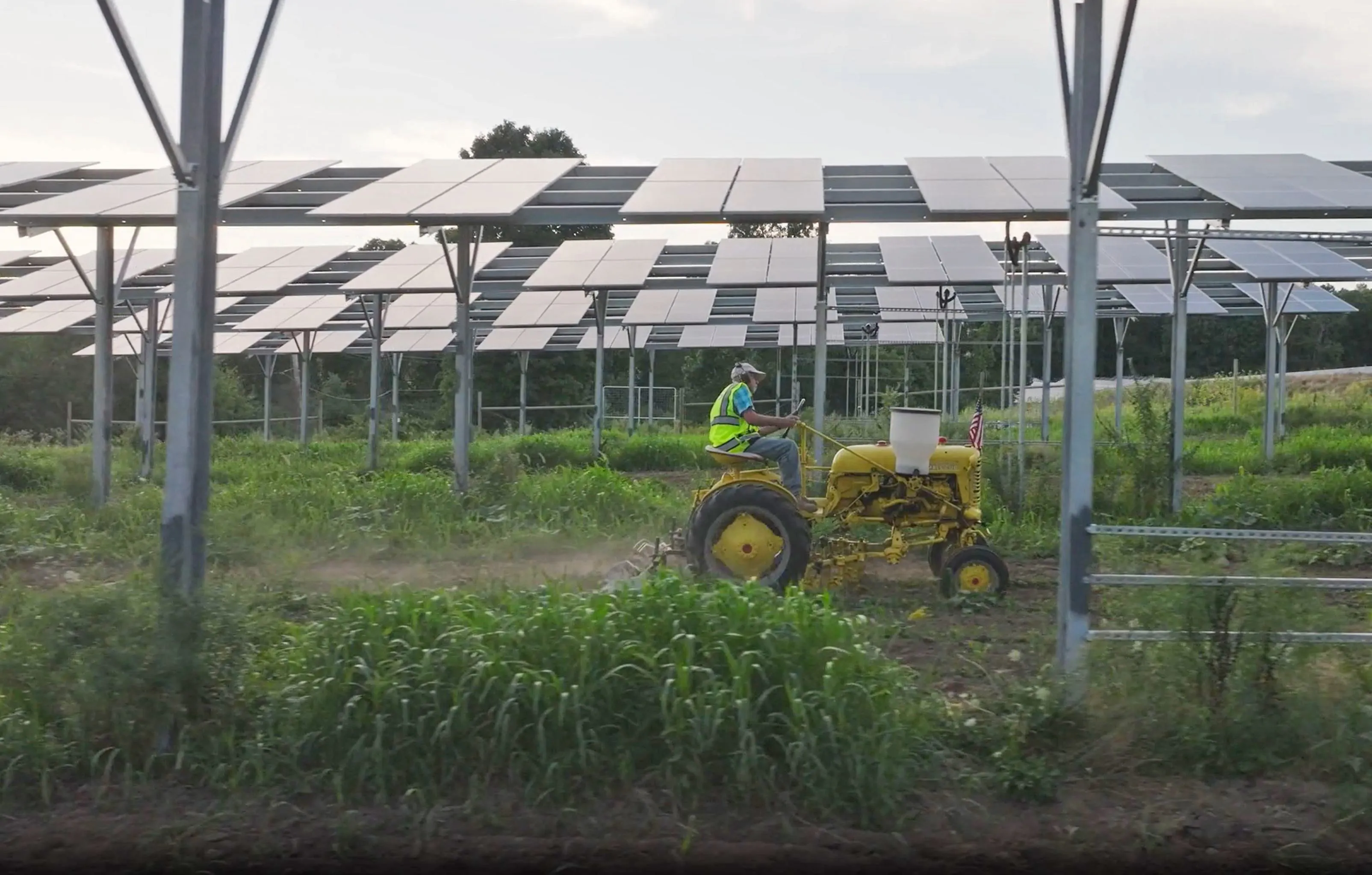 farmer-on-tractor-under-solar-panels-in-field.jpg