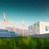 A landscape featuring solar panels, wind turbines, and a white container labeled 'Energy Storage' on a grassy field under a blue sky.