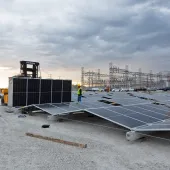 workers-installing-solar-panels-at-power-plant.jpg 