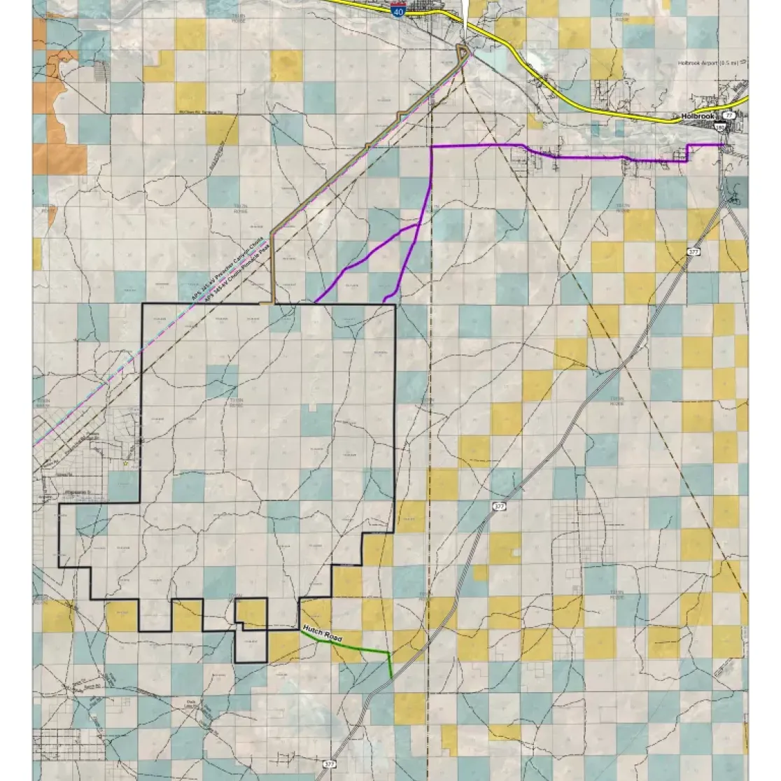 Map showing the West Camp Wind Farm in Navajo County, Arizona. The map includes highways, such as I-40, and locations like Joseph City and Holbrook. Colored grids indicate land sections, with a black outline marking the wind farm area. A purple line represents a power line route, and green labels indicate roads, including Hutch Road.