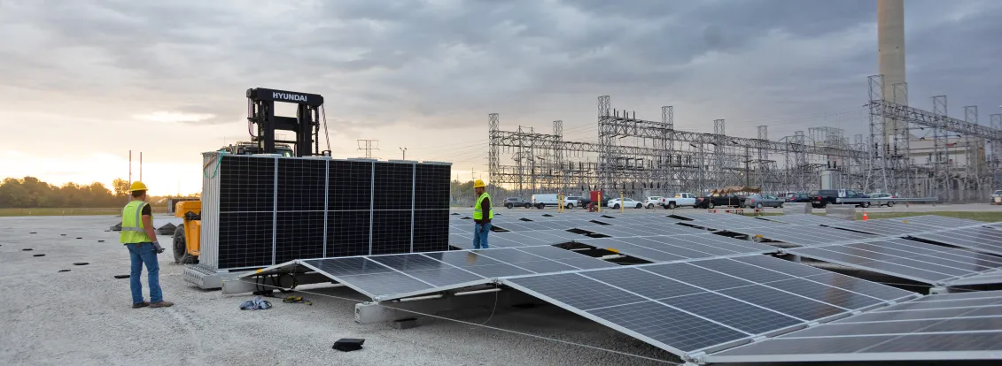 workers-installing-solar-panels-at-power-plant.jpg 