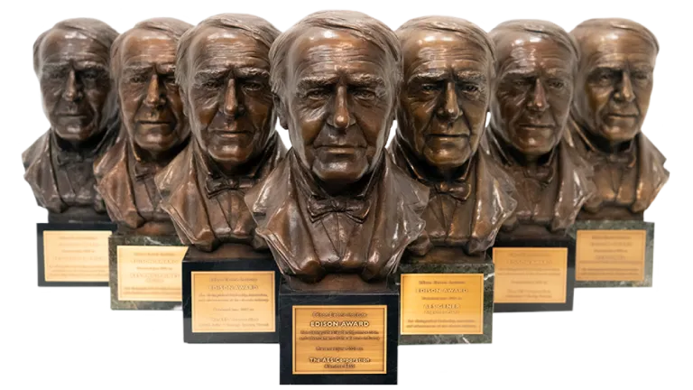 Multiple Edison Awards bronze bust trophies displayed in a row, recognizing innovation and excellence in the energy industry.