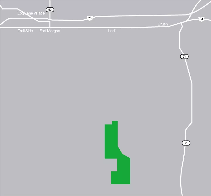 Map showing a gray background with major roads and highways labeled, including 52, 76, and 71. Locations such as Log Lane Village, Fort Morgan, and Brush are marked. A green area is highlighted in the lower center of the map.