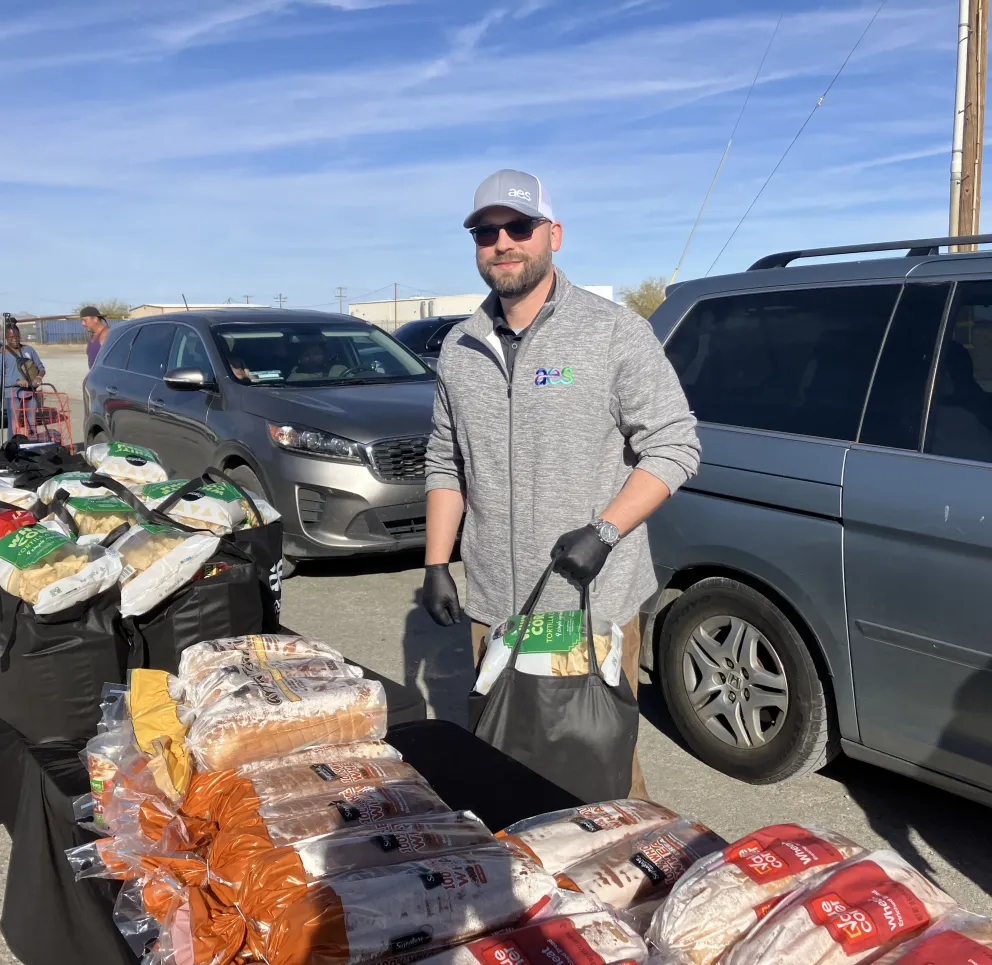 Rexford-aes-volunteer-distributing-food-at-community-drive-up-event.jpg
