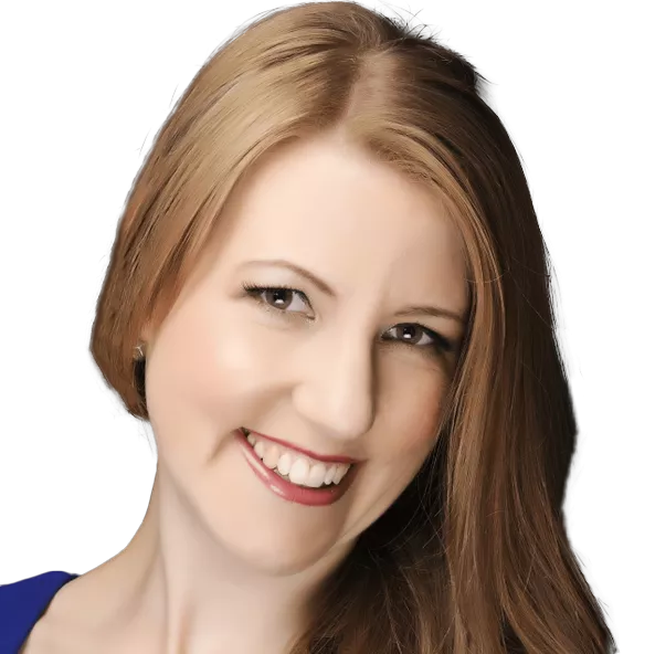 A woman with long, straight light brown hair smiles at the camera against a black background. She is wearing a blue top and has light makeup, including eyeliner and lipstick.