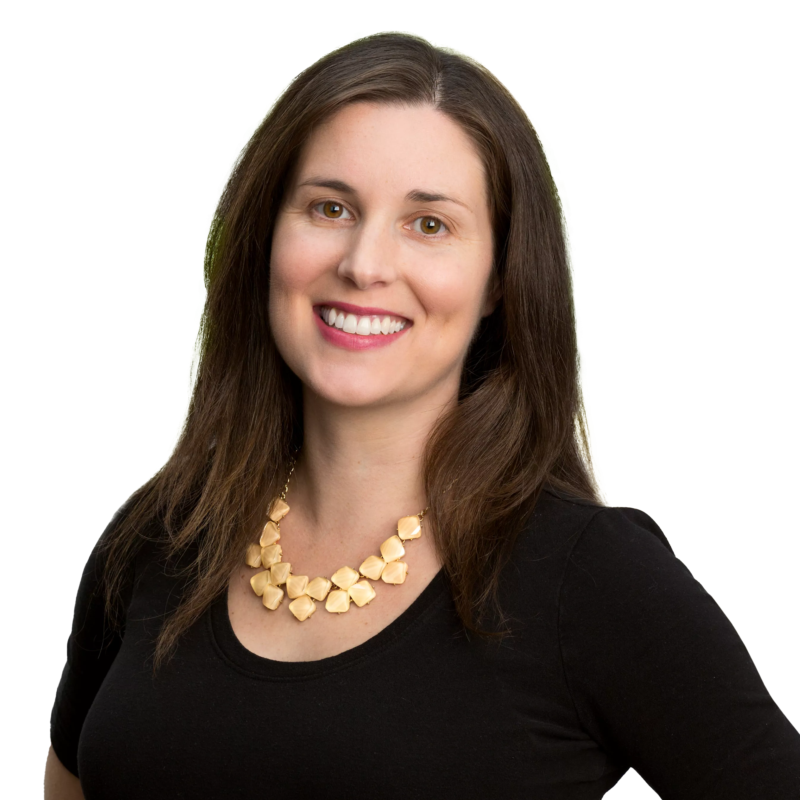 A woman with long brown hair wearing a black top and a gold necklace smiles at the camera against a plain background.