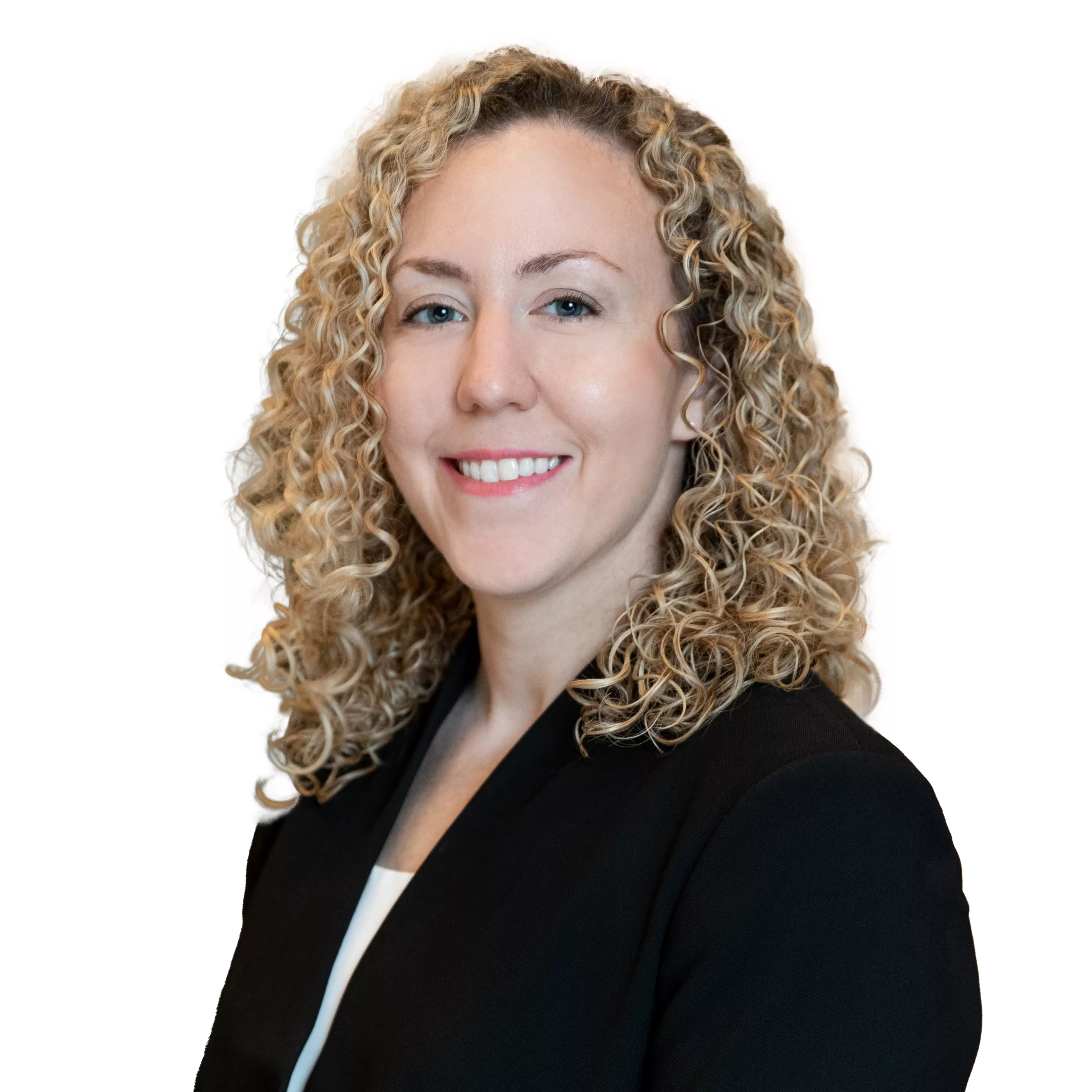A woman with curly blonde hair is smiling and wearing a black blazer over a white top. She is facing slightly to the left against a plain white background.