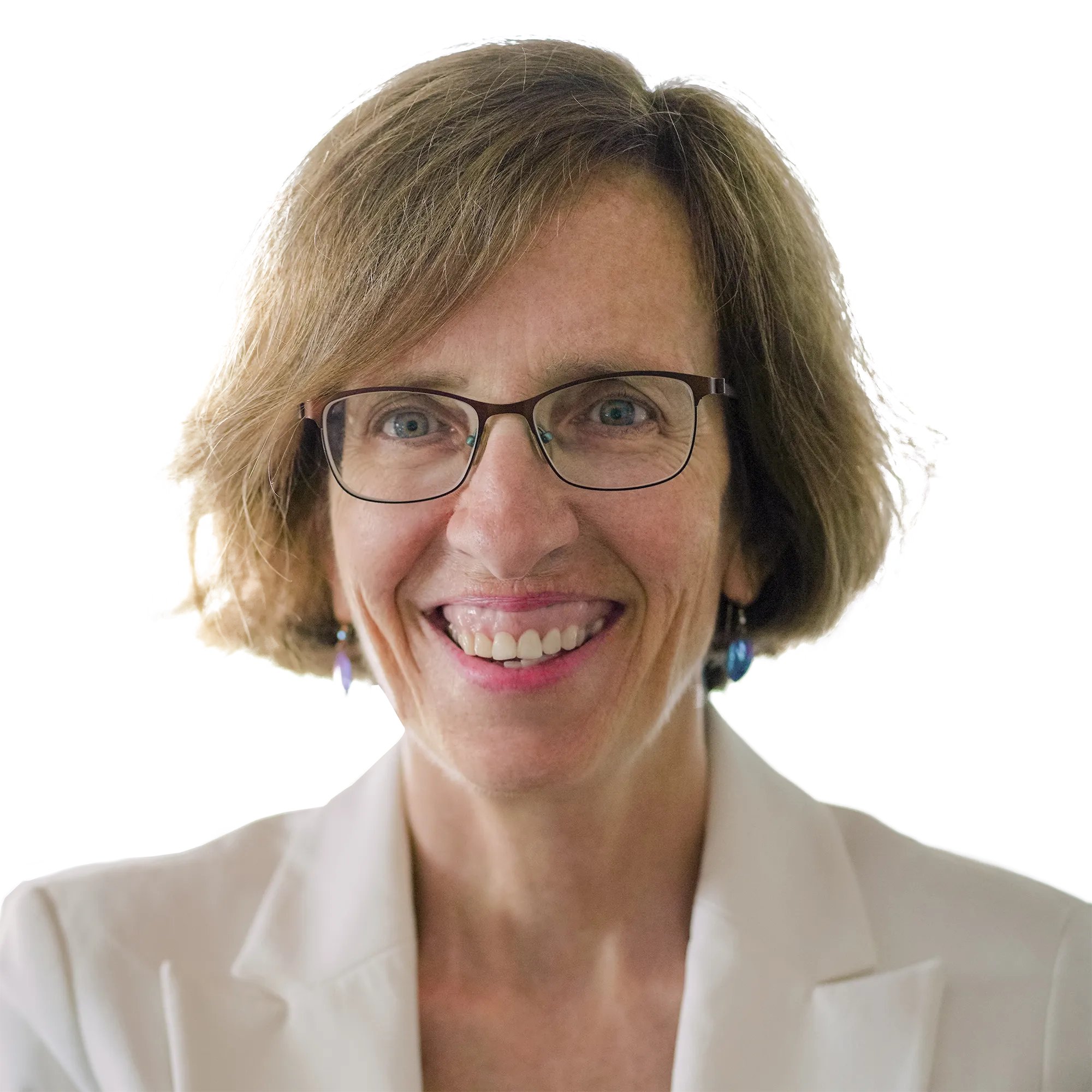 A woman with short brown hair and glasses smiling, wearing a white blazer.