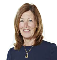 A woman with shoulder-length brown hair wearing a navy blue top and a necklace, smiling against a white background.