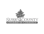 Logo of Surry County Chamber of Commerce featuring a tree silhouette above the text 'Surry County' with 'Chamber of Commerce' in a dark rectangle below.